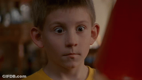 Boy In Yellow Shirt Standing In Kitchen GIF