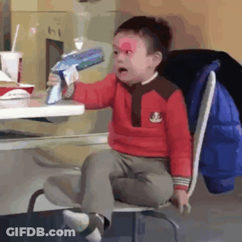 Boy In Yellow Shirt With Teddy Bear Eating Hamburger At McDonald's GIF