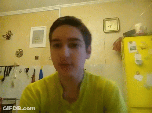 Boy In Yellow Shirt, Yellow Refrigerator, And Clock GIF