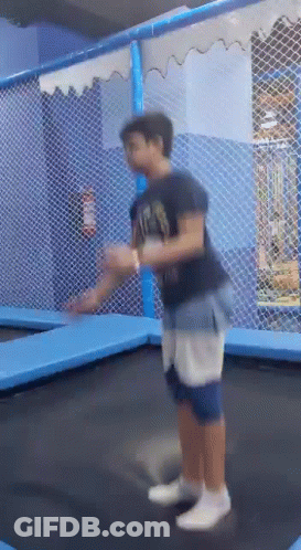 Boy Jumping On Trampoline In Playground GIF