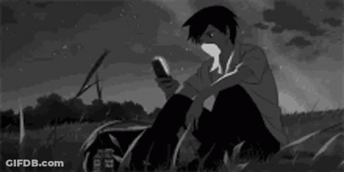 Boy Looking At Phone In Grass GIF