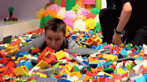 Boy Lying In Lego Bricks GIF