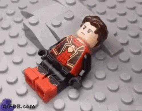 Boy Lying In Lego Bricks With Lego Sticker GIF