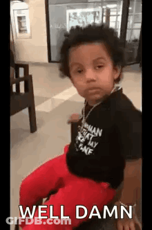 Boy Making Funny Face In Black Shirt And Red Pants GIF