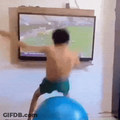 Boy On Blue Exercise Ball Before TV GIF