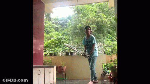 Boy Playing Cricket On Balcony GIF