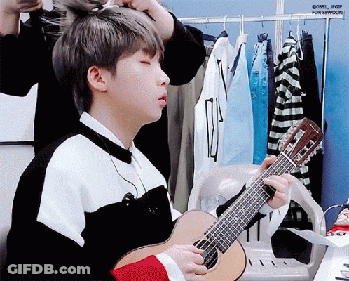 Boy Playing Guitar In Dressing Room Being Adjusted GIF