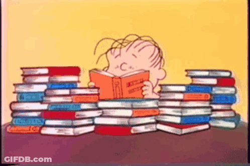 Boy Reading Book Surrounded By Books GIF