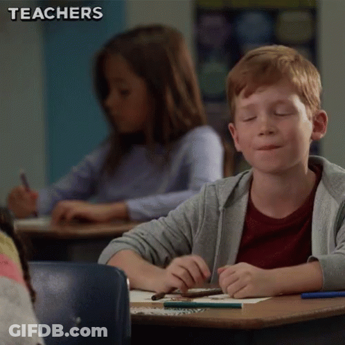 Boy Sitting At Desk Eyes Closed GIF