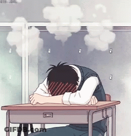 Boy Sitting At Desk With Head On Knees GIF