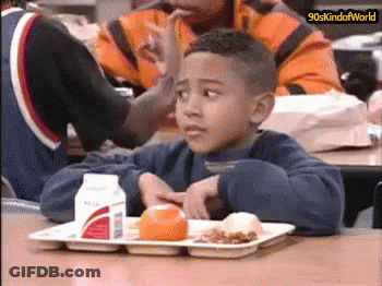 Boy Sitting At Table With Food And Milk GIF
