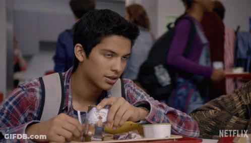 Boy Sitting At Table With Netflix Logo GIF