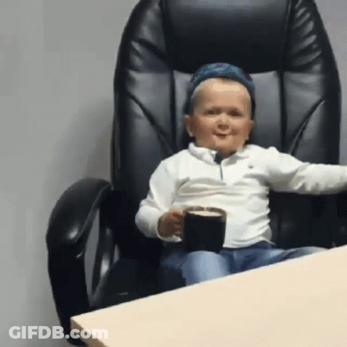 Boy Sitting In Chair Holding Coffee GIF