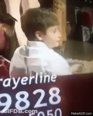 Boy Sitting In Front Of Prayerline 9828 Sign GIF