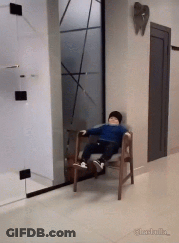 Boy Sitting In Hallway With Tooth GIF