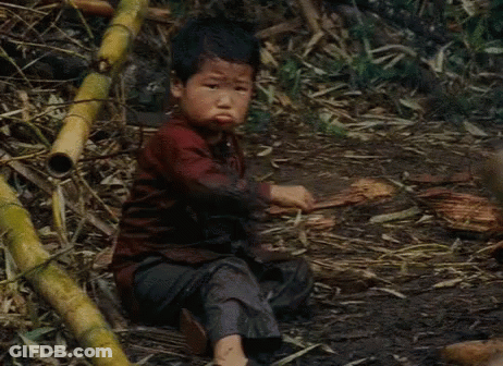 Boy Sitting In Mud With Crossed Arms GIF