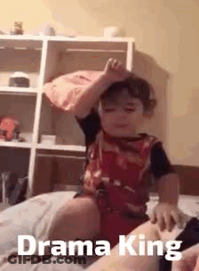 Boy Sitting On Bed With Crown GIF