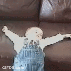 Boy Sitting On Couch With Outstretched Arms GIF