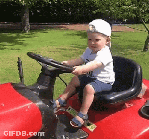 Boy Sitting On Red Lawn Mower GIF