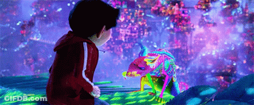Boy Sitting On Rock Looking At Colorful Lizard GIF