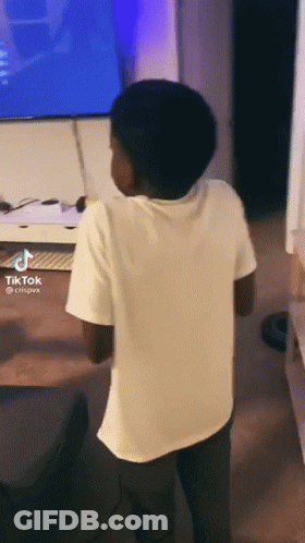 Boy Standing In Front Of TV With Tik Tok GIF