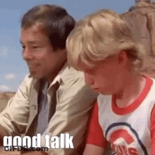 Boy Talking To Seated Man GIF