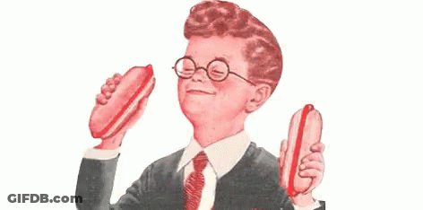 Boy Wearing Glasses And Tie Holding Two Hot Dogs GIF