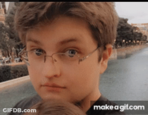 Boy Wearing Glasses Looking At Camera GIF