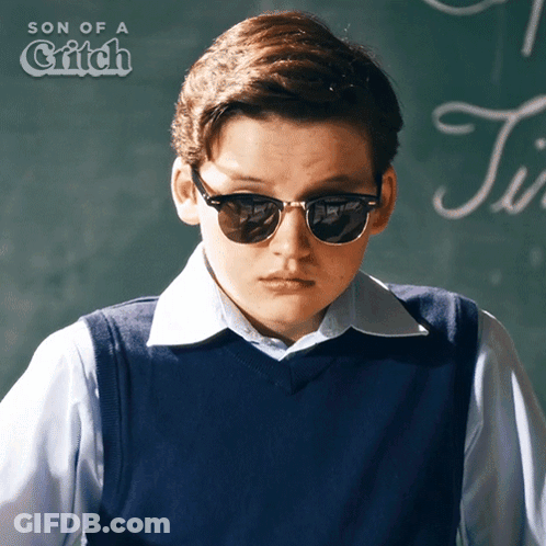 Boy Wearing Sunglasses In Front Of Blackboard GIF