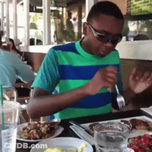 Boy Wearing Sunglasses Sitting At Table GIF