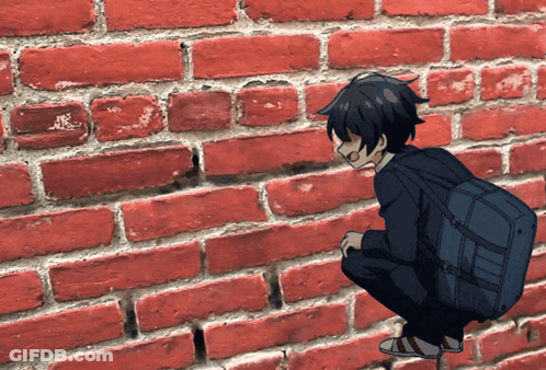 Boy With Backpack Squatting Against Brick Wall GIF