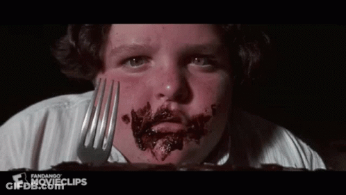 Boy With Chocolate Face Holding Fork GIF