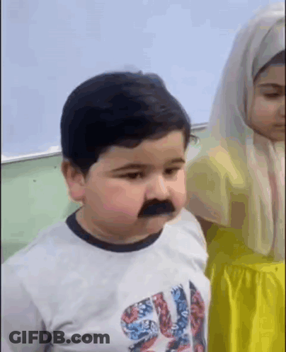 Boy With Fake Mustache And Girl In Yellow Dress GIF