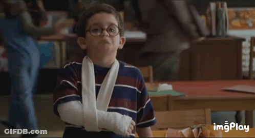 Boy With Glasses And Arm Cast In Classroom GIF