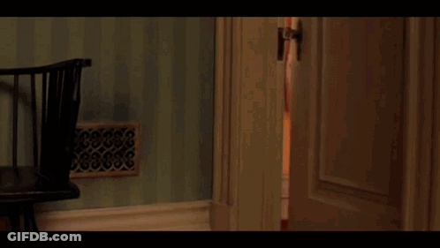 Boy With Glasses And Red Jacket By Green Wall GIF