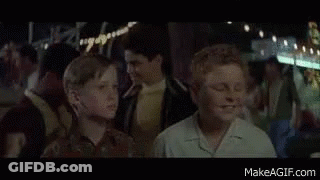 Boy With Glasses In Front Of T2 Sign GIF