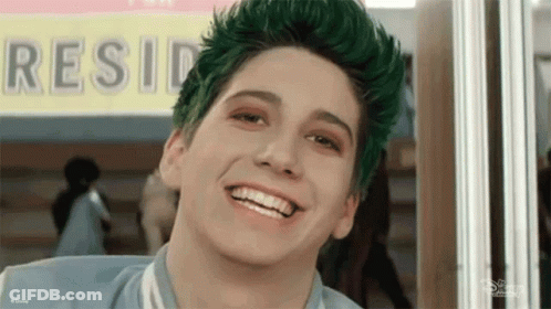 Boy With Green Hair Smiling In Front Of Resid Sign GIF