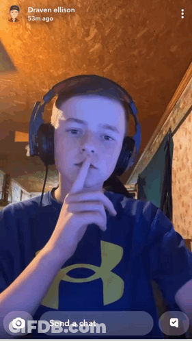 Boy With Headphones Shushing In Blue Under Armour Shirt GIF