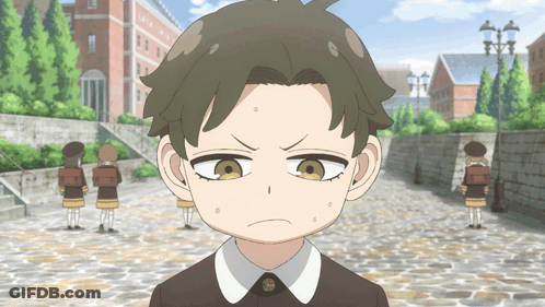 Boy With Serious Look On Cobblestone Street GIF