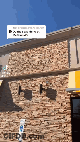 Brick Building With Yellow Awning GIF