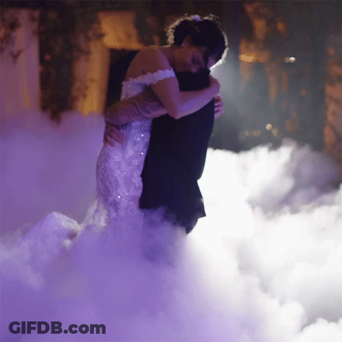Bride And Groom Hugging In Foggy Room GIF