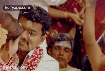 Bride And Groom Kissing At Wedding With Confetti GIF