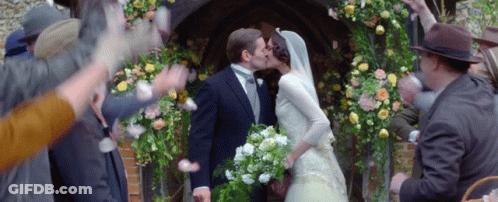 Bride And Groom Kissing In Front Of Crowd GIF
