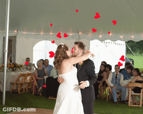Bride And Groom Kissing Under White Tent GIF