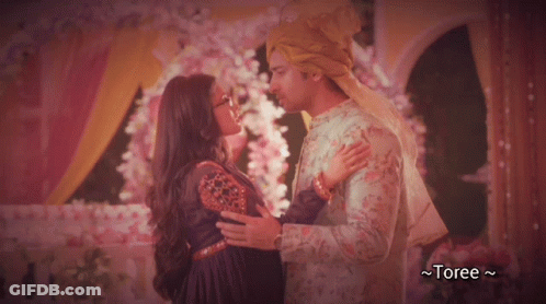 Bride And Groom Kissing With Flowers And Toree GIF