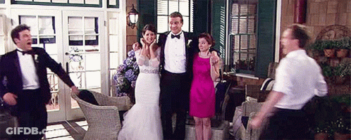 Bride And Groom Posing With Wedding Guests On Porch GIF