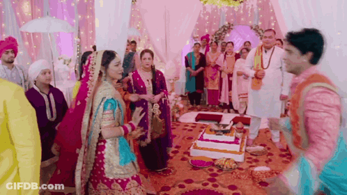 Bride And Groom Standing Before Cake GIF