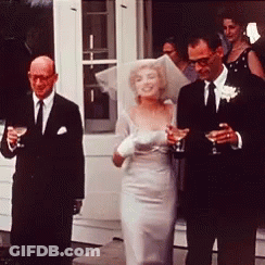 Bride And Groom Walking Down Aisle Holding Wine Glasses GIF