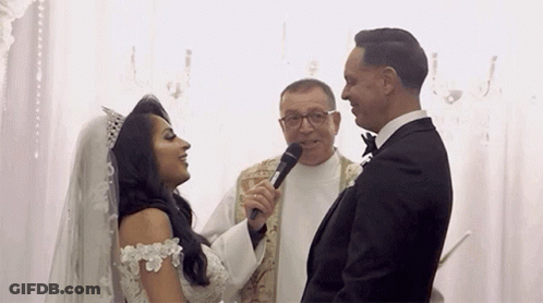 Bride And Groom With Priest Holding Microphone GIF