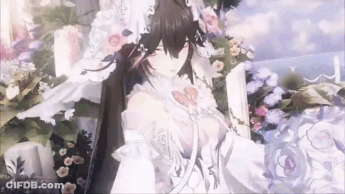 Bride In Wedding Dress Standing In Front Of Bouquet GIF
